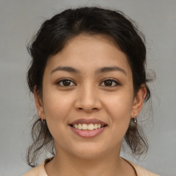 Joyful latino young-adult female with medium  brown hair and brown eyes