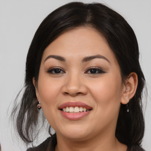 Joyful asian young-adult female with medium  brown hair and brown eyes
