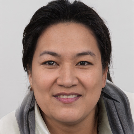 Joyful asian adult female with short  brown hair and brown eyes