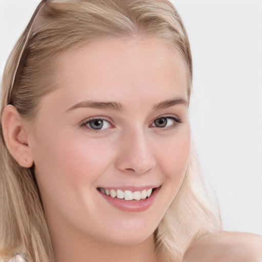 Joyful white young-adult female with long  brown hair and blue eyes