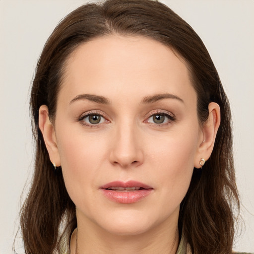 Joyful white young-adult female with long  brown hair and brown eyes