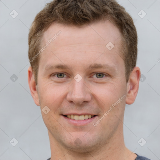 Joyful white young-adult male with short  brown hair and grey eyes