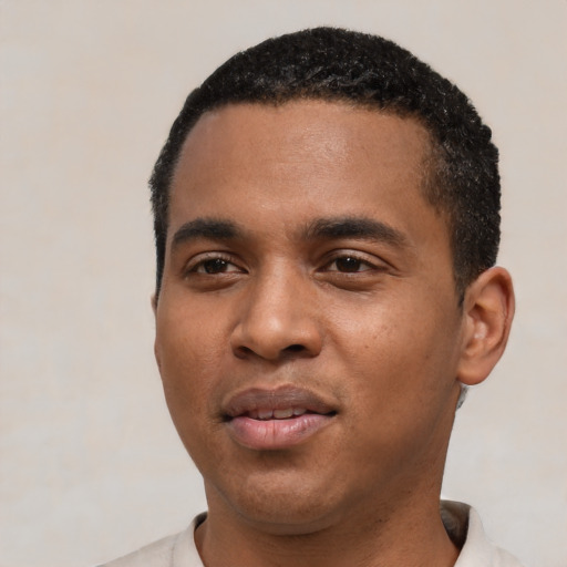 Joyful black young-adult male with short  black hair and brown eyes