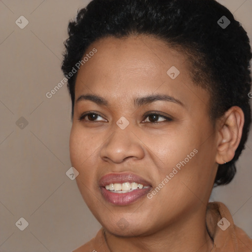 Joyful black young-adult female with short  black hair and brown eyes