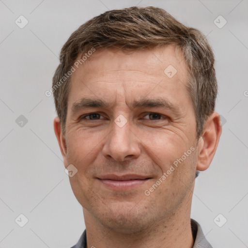 Joyful white adult male with short  brown hair and grey eyes