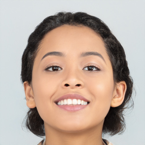 Joyful latino young-adult female with medium  black hair and brown eyes