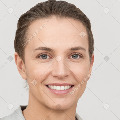 Joyful white young-adult female with short  brown hair and grey eyes