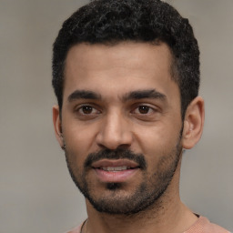 Joyful latino young-adult male with short  black hair and brown eyes