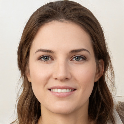 Joyful white young-adult female with long  brown hair and grey eyes