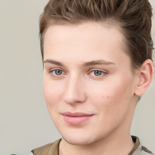 Joyful white young-adult female with short  brown hair and grey eyes