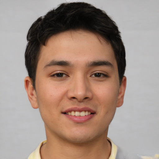 Joyful asian young-adult male with short  brown hair and brown eyes