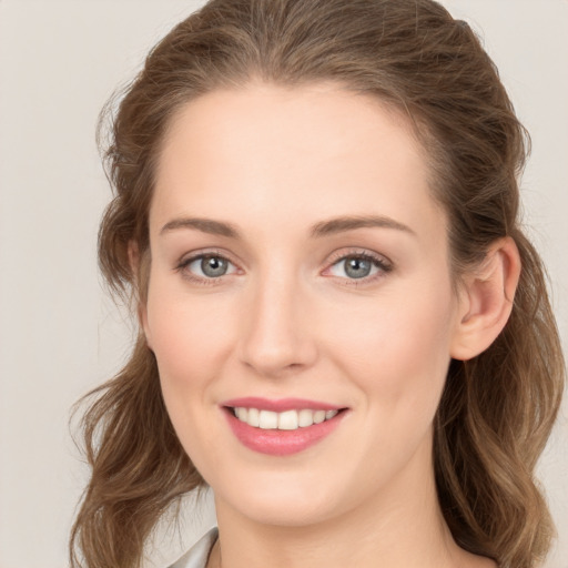 Joyful white young-adult female with long  brown hair and grey eyes