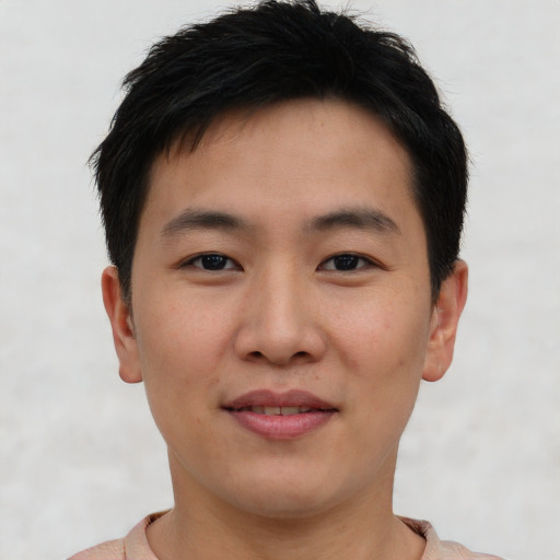 Joyful asian young-adult male with short  brown hair and brown eyes