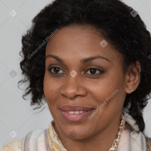 Joyful black adult female with medium  brown hair and brown eyes