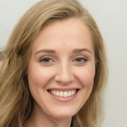 Joyful white young-adult female with long  brown hair and green eyes