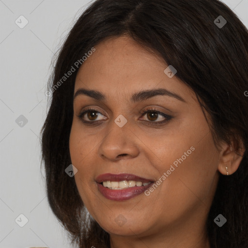 Joyful latino young-adult female with long  brown hair and brown eyes