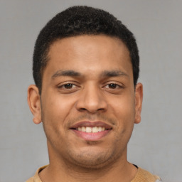 Joyful latino young-adult male with short  brown hair and brown eyes