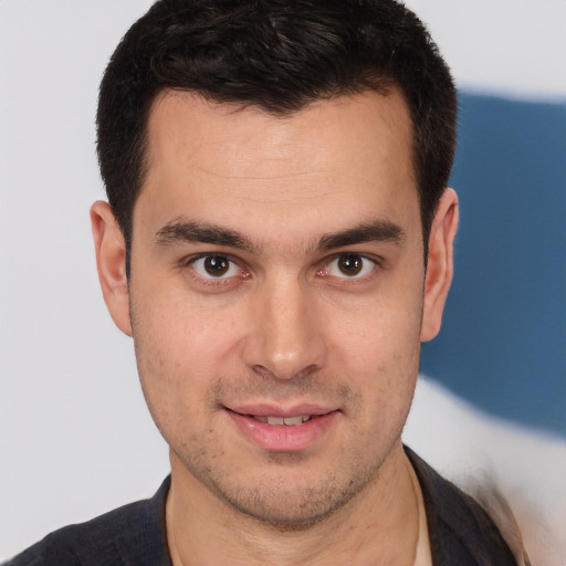 Joyful white young-adult male with short  brown hair and brown eyes