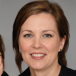 Joyful white adult female with medium  brown hair and brown eyes