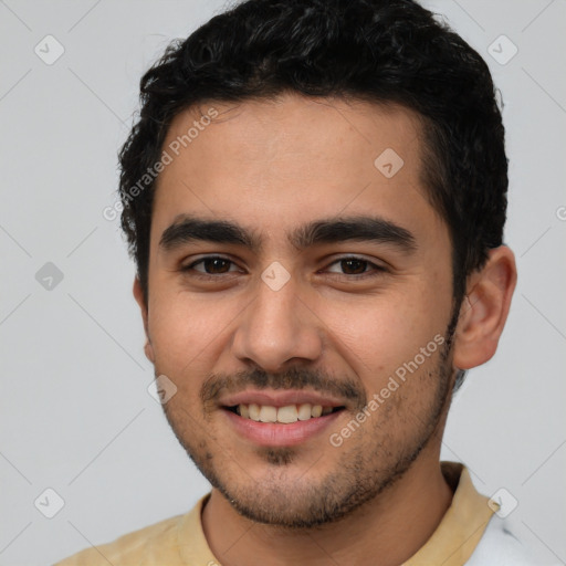 Joyful latino young-adult male with short  black hair and brown eyes