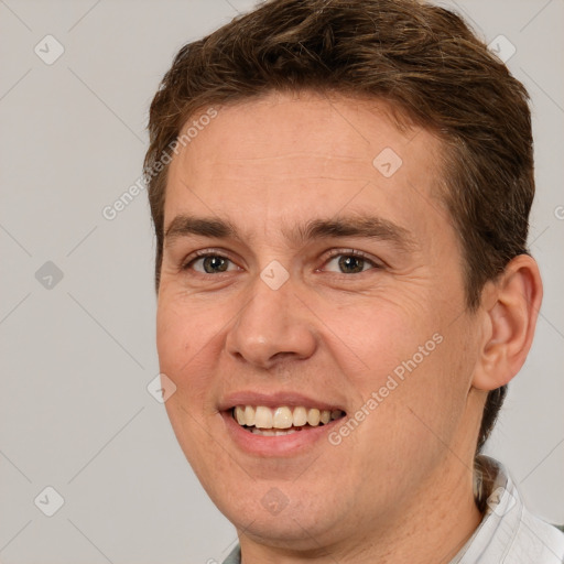 Joyful white adult male with short  brown hair and brown eyes