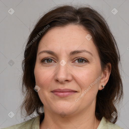 Joyful white adult female with medium  brown hair and grey eyes