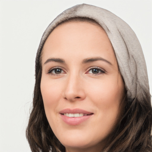 Joyful white young-adult female with long  brown hair and brown eyes