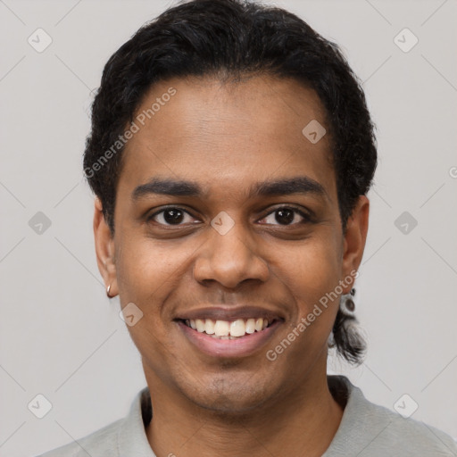 Joyful black young-adult male with short  black hair and brown eyes