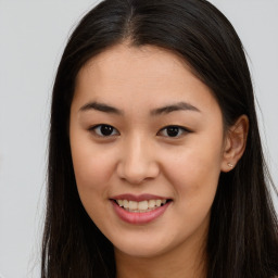 Joyful asian young-adult female with long  brown hair and brown eyes