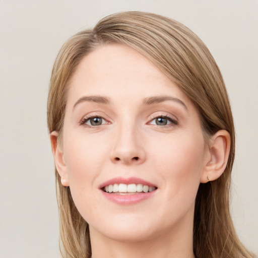 Joyful white young-adult female with long  brown hair and blue eyes