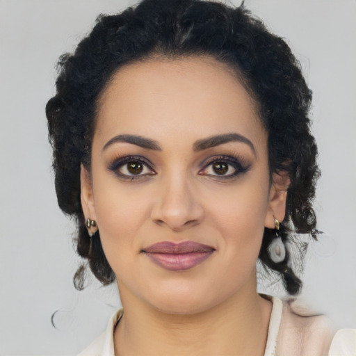 Joyful black young-adult female with long  black hair and brown eyes