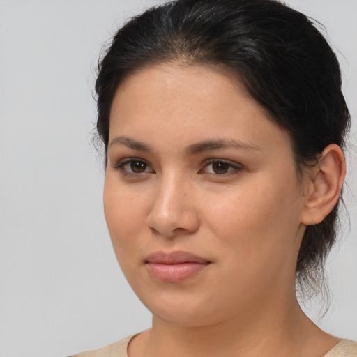 Joyful latino young-adult female with medium  brown hair and brown eyes