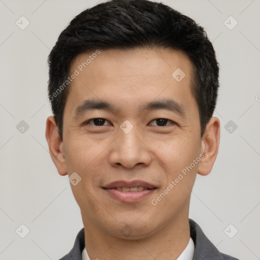 Joyful asian young-adult male with short  black hair and brown eyes