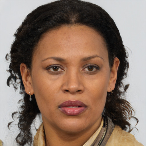 Joyful black adult female with medium  brown hair and brown eyes