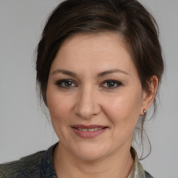 Joyful white adult female with medium  brown hair and brown eyes