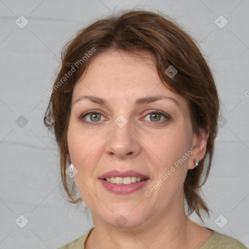 Joyful white adult female with medium  brown hair and green eyes