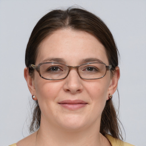 Joyful white adult female with medium  brown hair and brown eyes