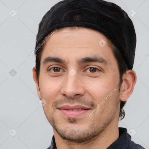 Joyful white young-adult male with short  black hair and brown eyes