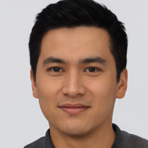 Joyful asian young-adult male with short  black hair and brown eyes