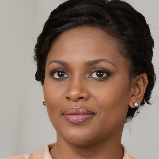 Joyful black young-adult female with medium  brown hair and brown eyes