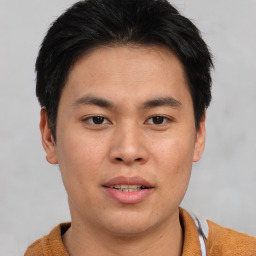 Joyful asian young-adult male with short  brown hair and brown eyes