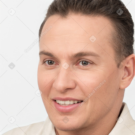 Joyful white adult male with short  brown hair and brown eyes