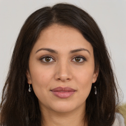 Joyful white young-adult female with long  brown hair and brown eyes