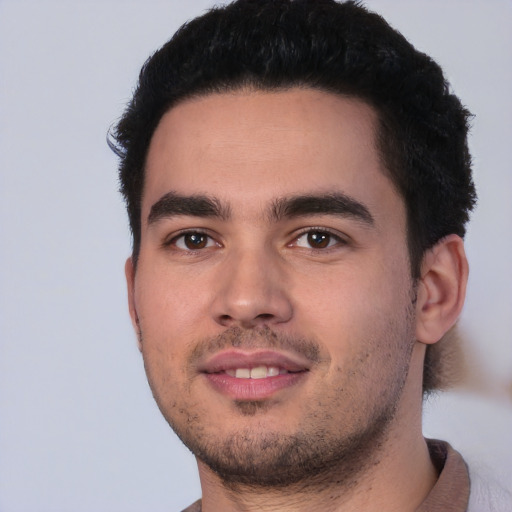 Joyful white young-adult male with short  black hair and brown eyes