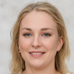 Joyful white young-adult female with medium  brown hair and blue eyes