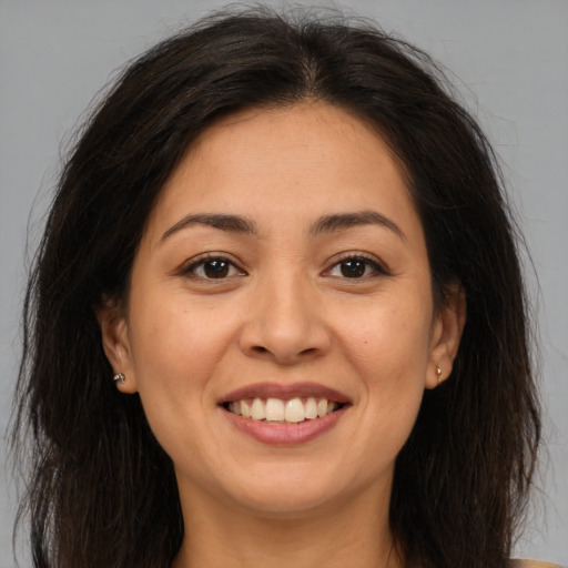 Joyful asian young-adult female with long  brown hair and brown eyes