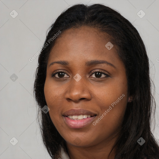 Joyful black young-adult female with long  brown hair and brown eyes