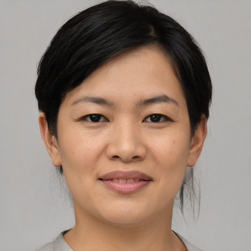 Joyful asian young-adult female with medium  black hair and brown eyes