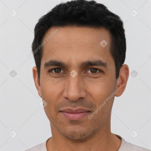 Joyful latino young-adult male with short  black hair and brown eyes