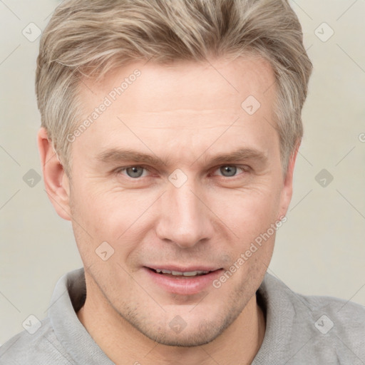 Joyful white adult male with short  brown hair and grey eyes